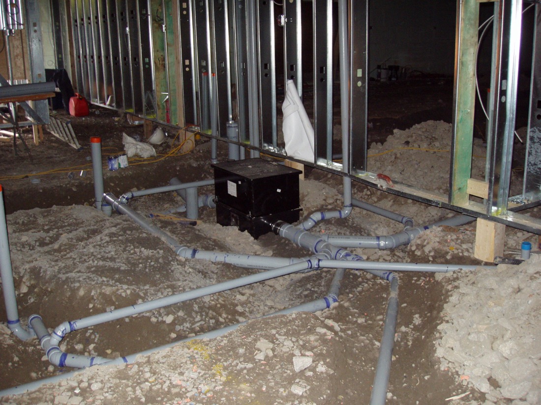 Grease interceptor set in a commercial kitchen floor before the slab is poured