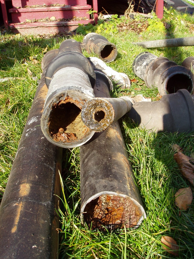 Old cast iron stack with a repaired joint in a basement